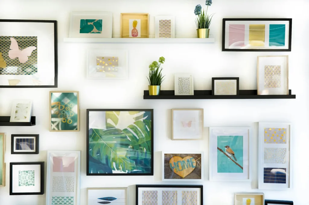 A dense gallery wall of framed prints and photographs, evenly spaced.