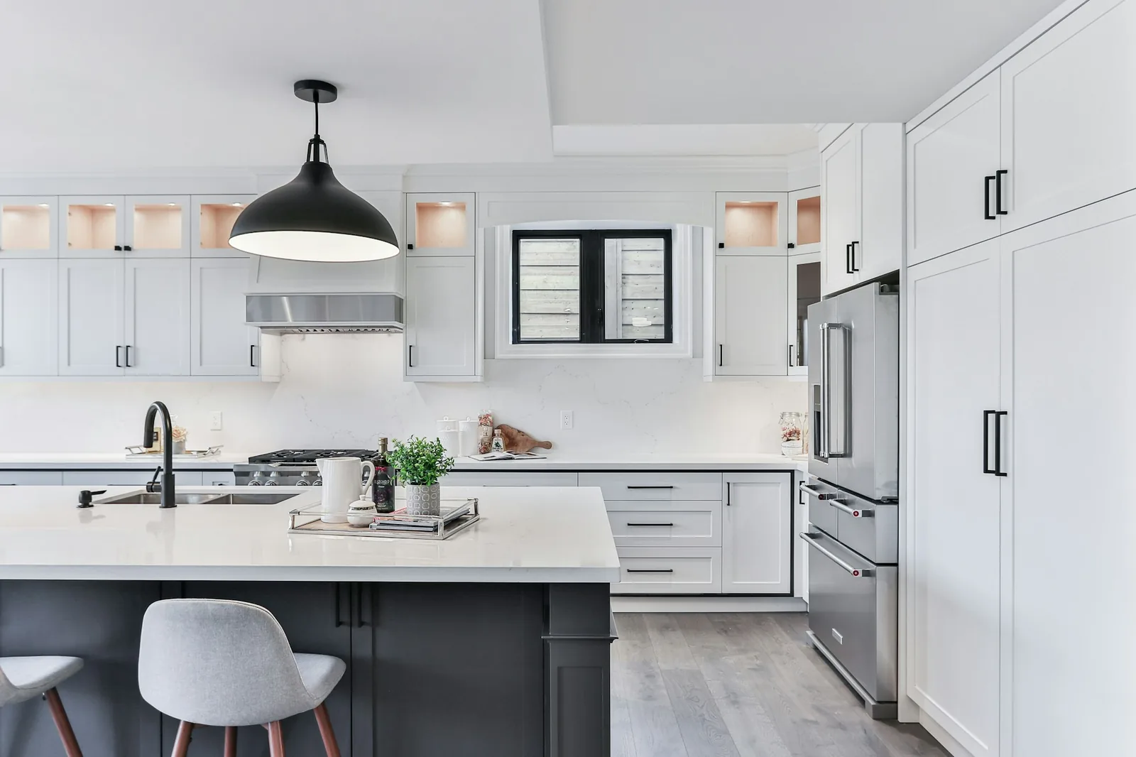 A white kitchen with flat-fronted cabinetry and an integrated hob.