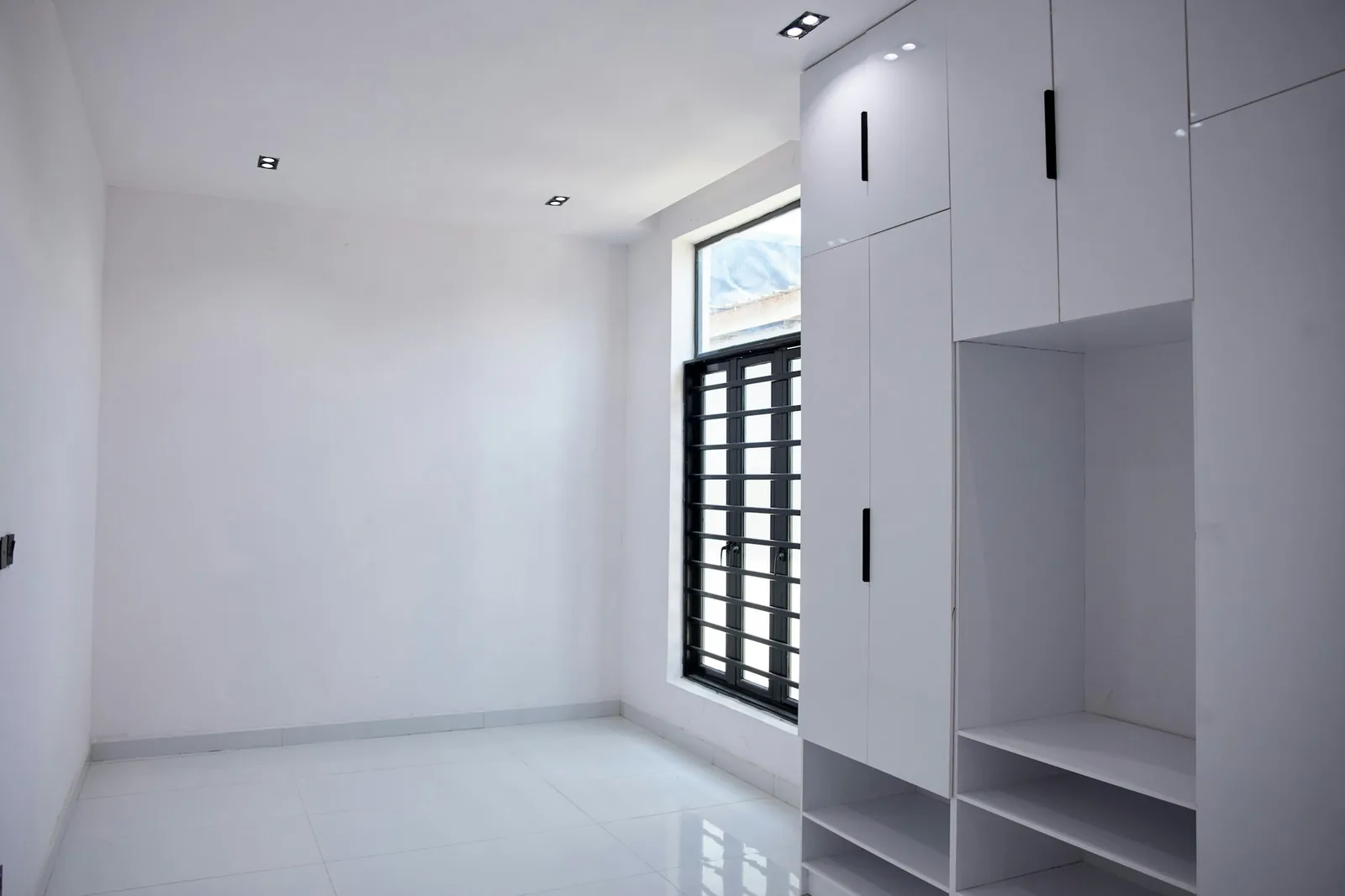 Built-in wardrobe joinery with open shelving and hanging space.