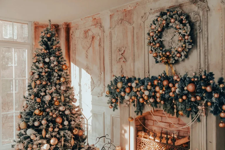 A decorated tree and a garlanded mantel in soft copper and cream.