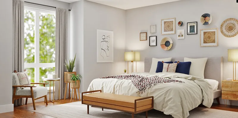 Bedroom staged for sale: layered cream linen, a timber bench at the foot of the bed and framed prints above.