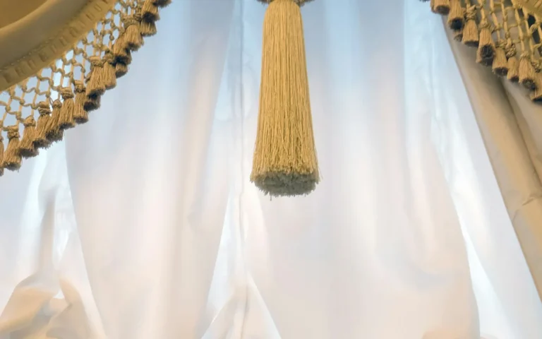 Sheer curtains held back with a tasselled tie-back.