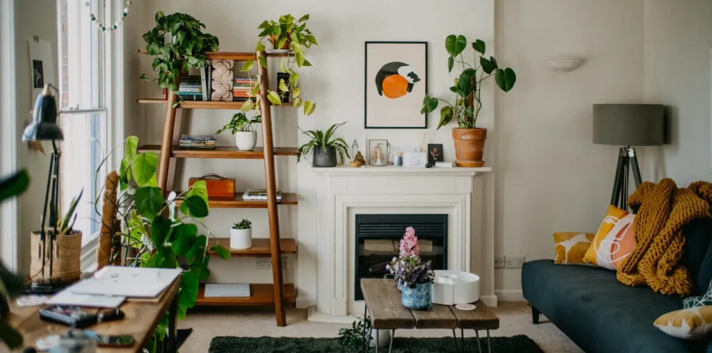 A lived-in living room before styling: shelves overfull, the table covered and the seating crowded.